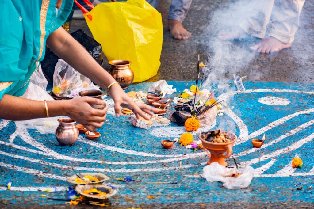 An immersive capture of a Hindu ritual at Ganga Ghat with flowers and sacred elements.
