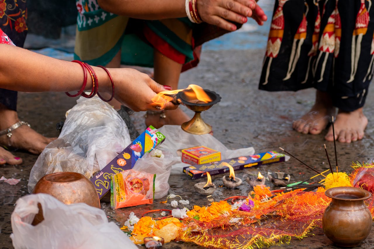 Photograph of a vibrant Hindu ritual ceremony in Kolkata, showcasing traditional offerings and cultural attire.